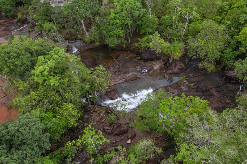 Overhead aerial view of Cachoeira do Traíra: water flowing between rocks in dense forest